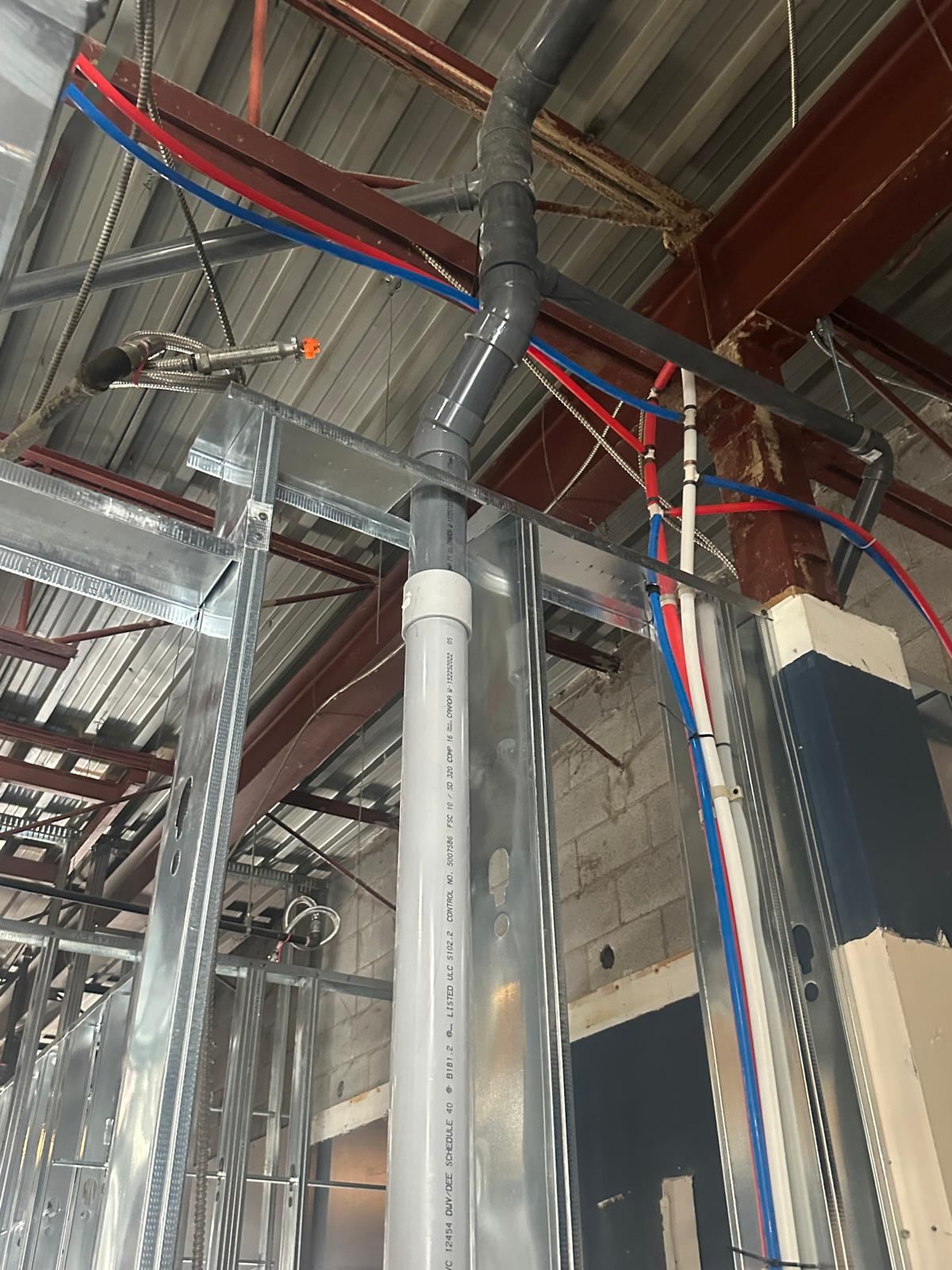 Overhead drain riser and PEX distribution lines